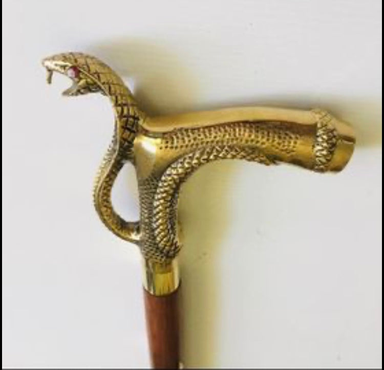 Walking Stick with Large Snakes Head Brass Handle on Brown Stick with brass inlay.