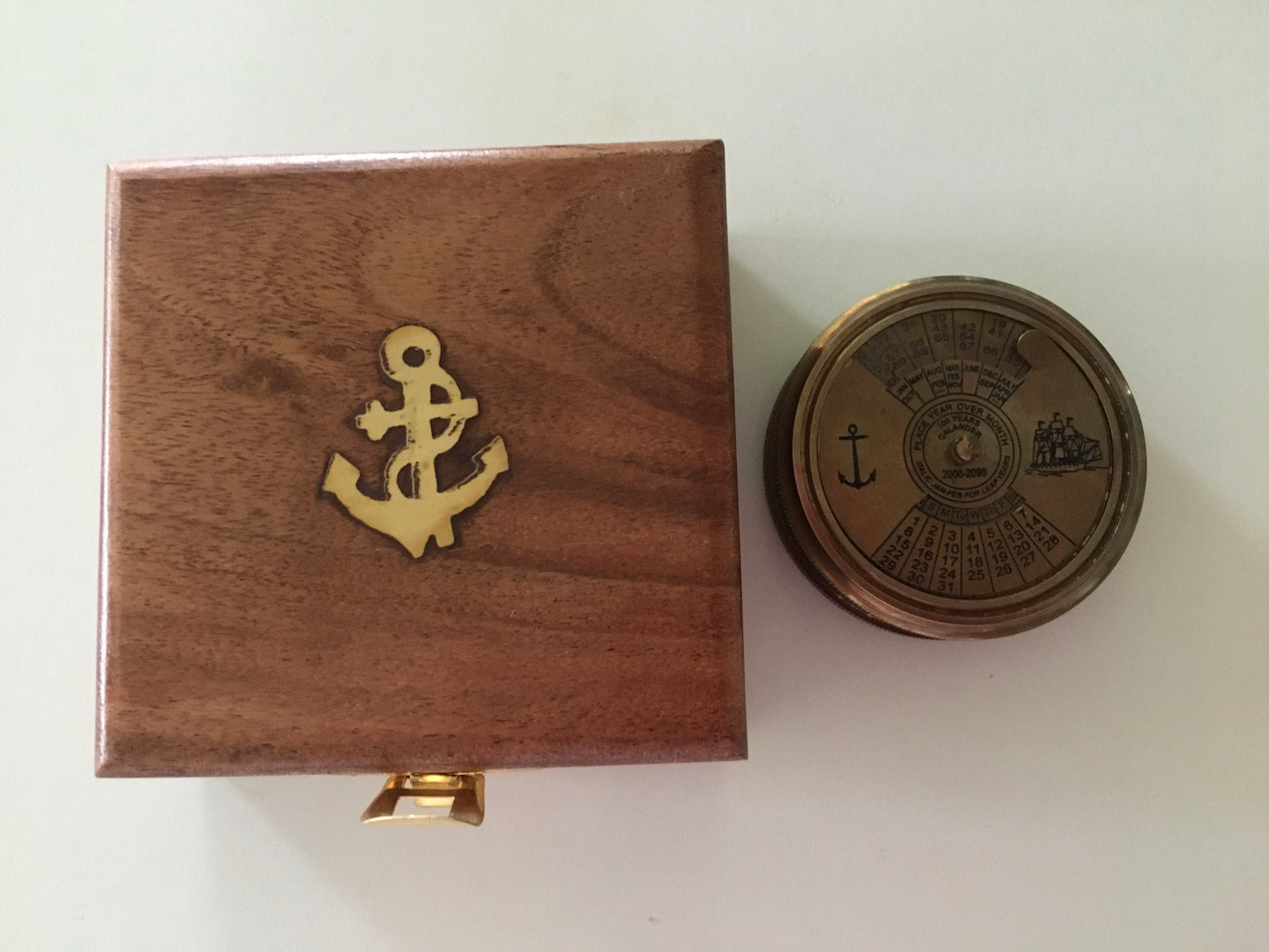 Nautical compass in shiny brass with 100 year calendar