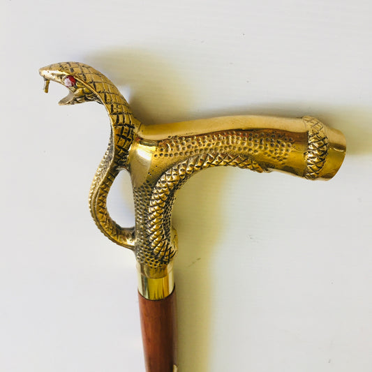 Walking Stick with Large Snakes Head Brass Handle on Brown Stick with brass inlay.