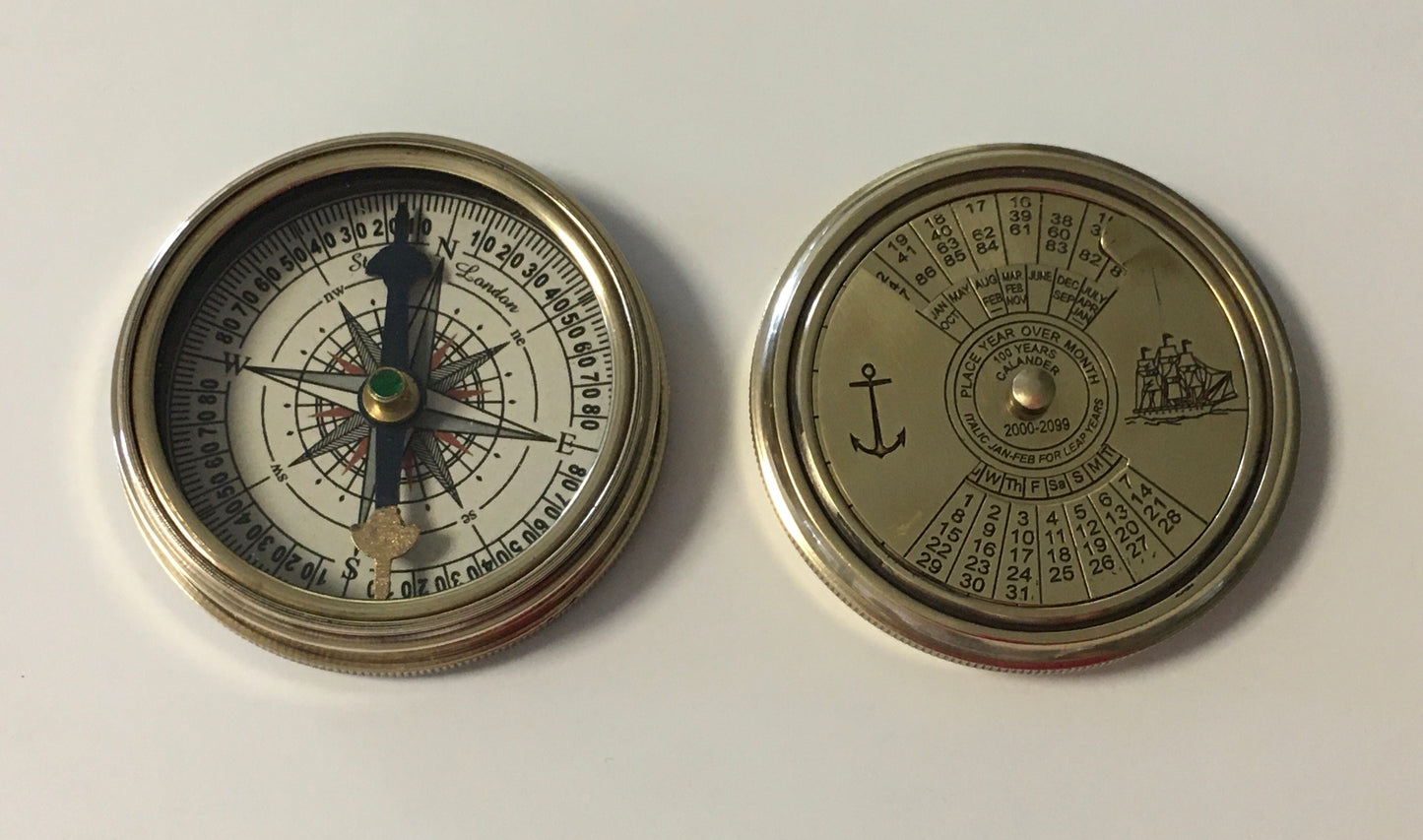 Nautical compass in shiny brass with 100 year calendar