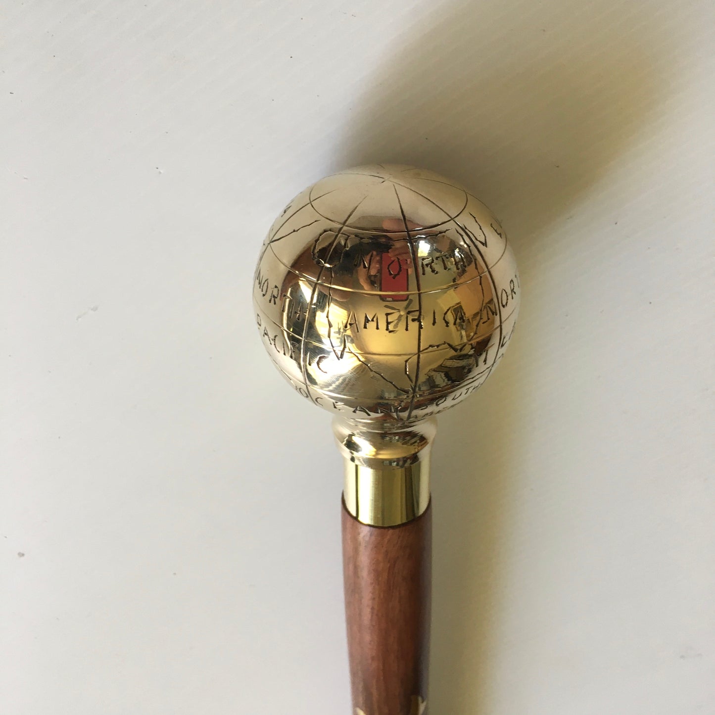 Walking Stick with Shiny Brass Globe Handle on a lovely brown stick with brass inlay